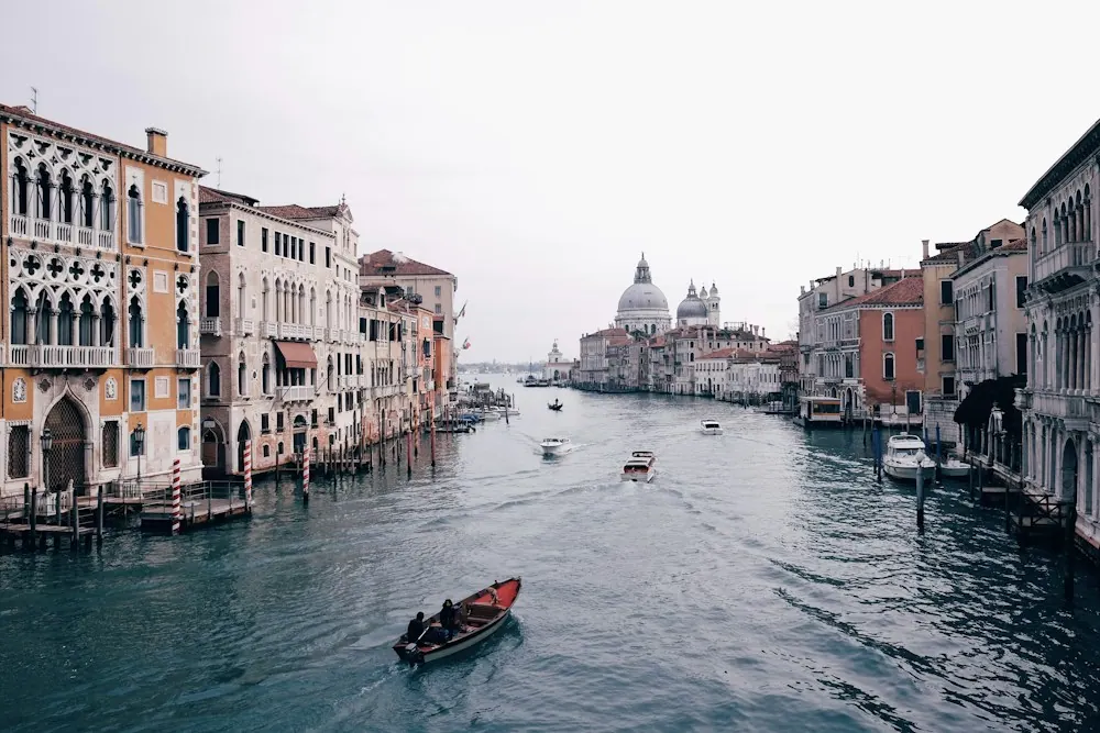 Boats and historic buildings along the Grand Canal in Venice.