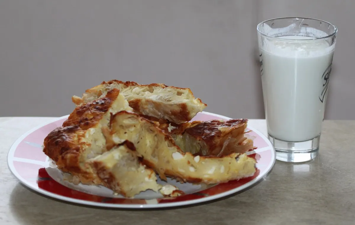 Banitsa pastry served with a yogurt drink.