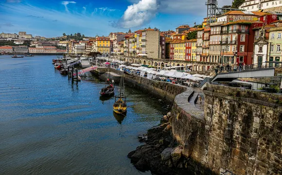 Colourful buildings and rabelo boats along Porto’s Ribeira waterfront.