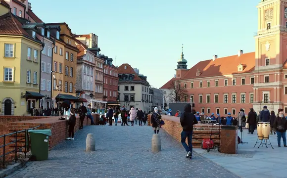 People walking through Castle Square in Warsaw, Poland.