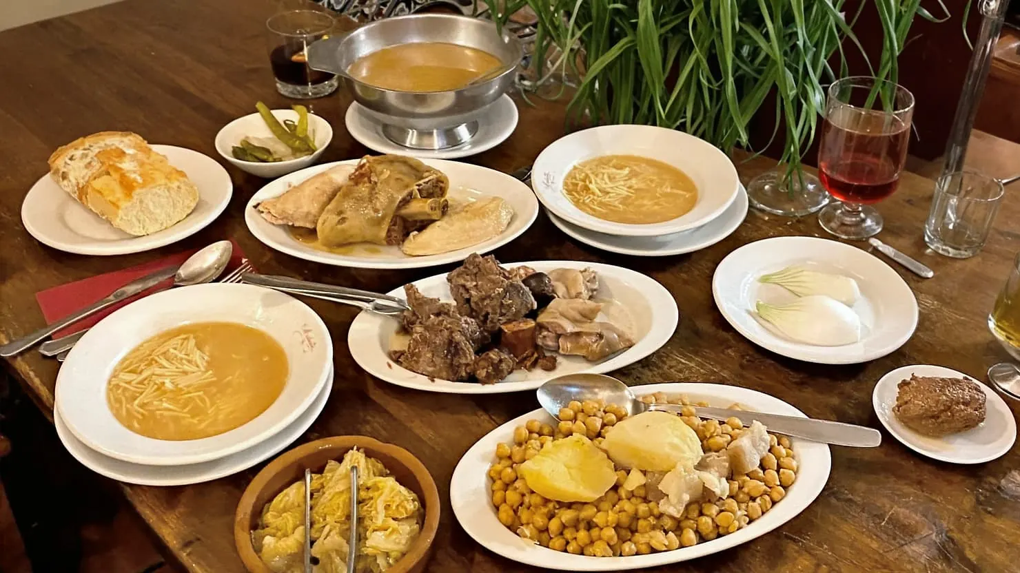Cocido Madrileño in a table served in different dishes