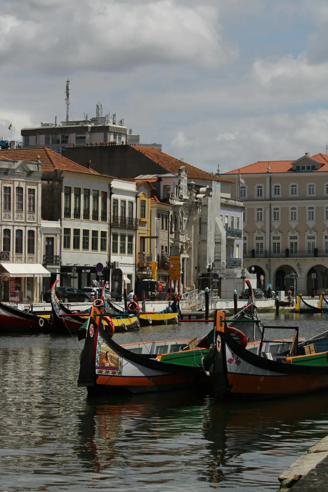 Traditionnal moliceiro boats on a canal in Aveiro,Portugal, witch historic buildings in the background