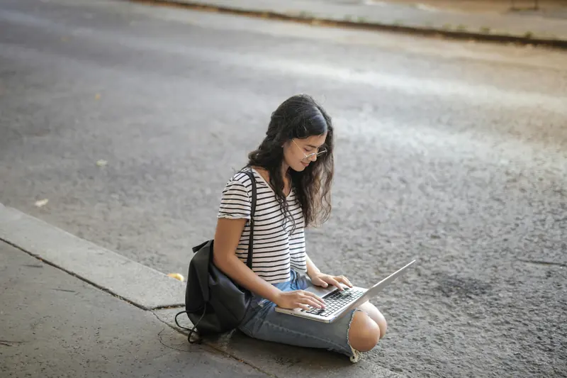 Digital nomad exploring the colorful streets of Porto, Portugal, during sunset — stepping away from the screen to recharge.