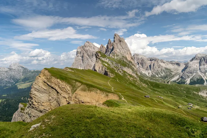 Green Grass Field And Mountain Under Blue Sky
