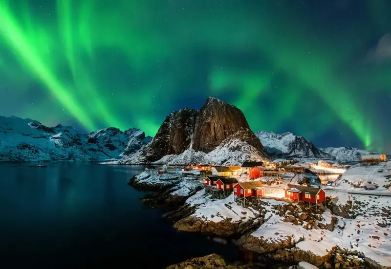 The northern lights sometimes ripple above the frozen peaks
