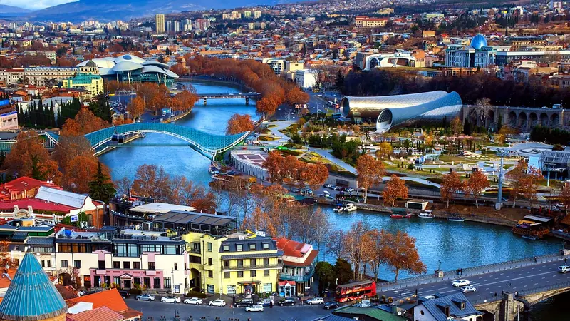 Aerial view of Tbilisi with the Bridge of Peace, Rike Park and Old Town rooftops