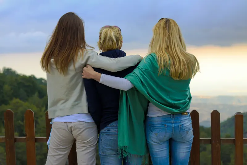 Three women hugging each other