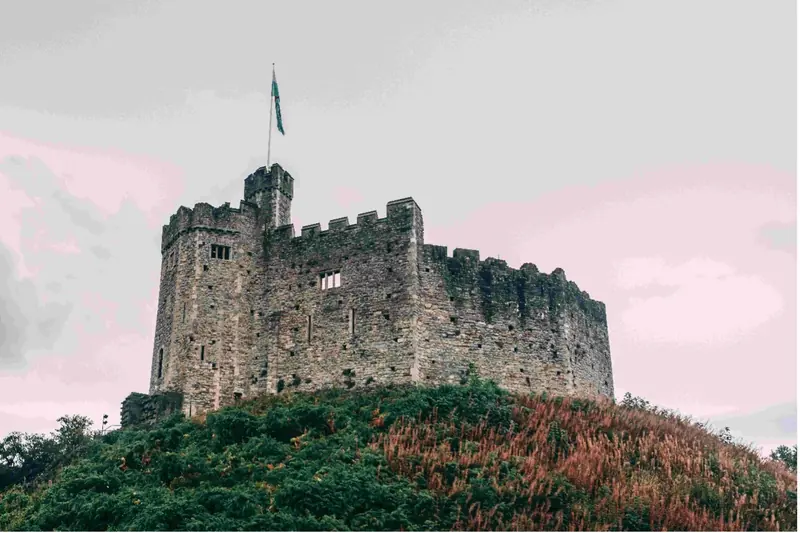 Stone castle with a flag in the sunset
