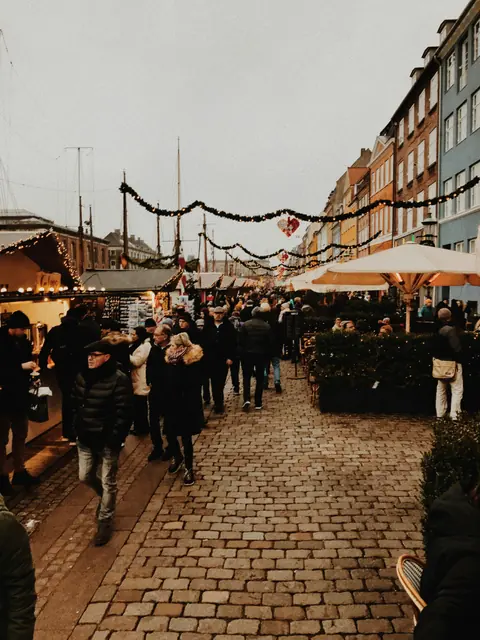 Twinkling Christmas market stalls in Wrocław, Poland, glowing under festive lights during a calm winter evening.