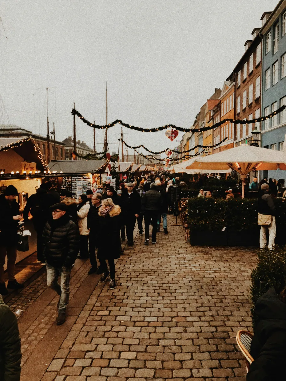 Twinkling Christmas market stalls in Wrocław, Poland, glowing under festive lights during a calm winter evening.