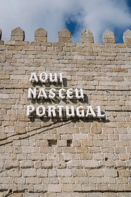 "Aqui nasceu Portugal" sign on stone wall Guimarães historic center