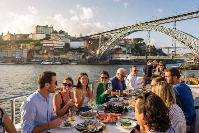 Guests at an outdoor table beside the Douro and Dom Luís I Bridge.